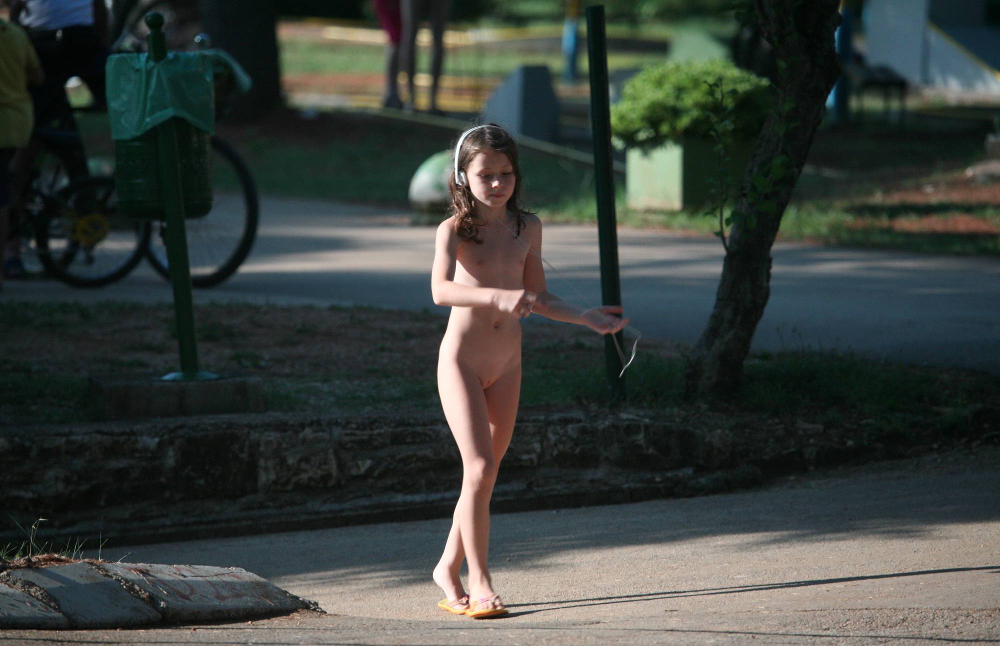 Nudist Life Girl Playing Her MP3 Player - 2